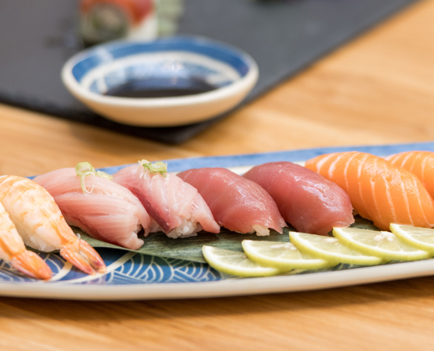 Lahaina Sushi Ko - sushi on a plate - two shrimp, two hamachi, two ahi and two salmon with wasabi and lemon on the side