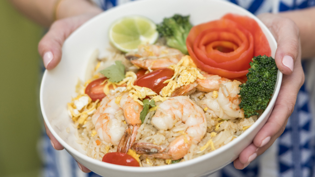 Lahaina Thai Ono - Shrimp Fried Rice in a bowl with lime, broccoli and a side of tomato shaved like a flower