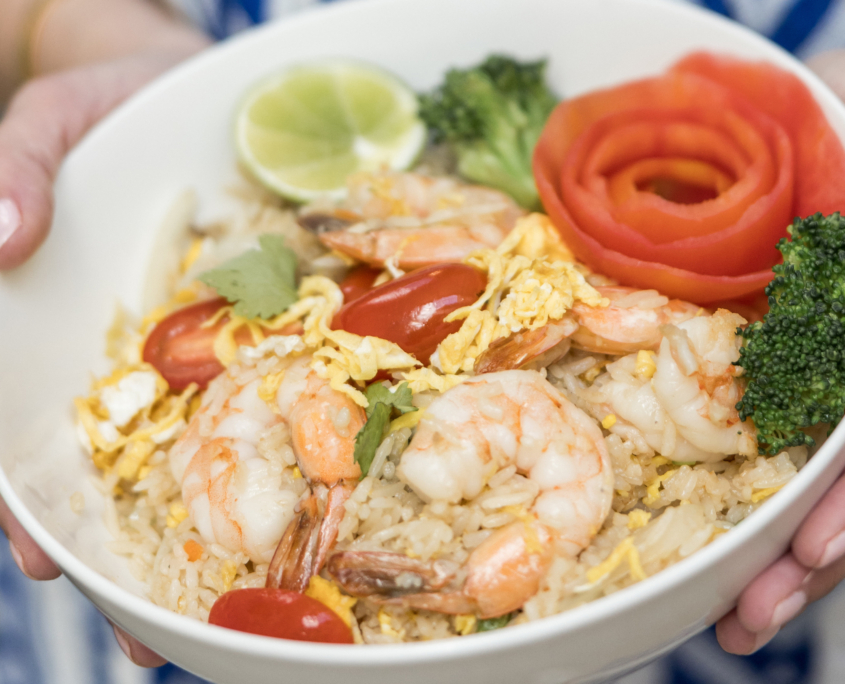 Lahaina Thai Ono - Shrimp Fried Rice in a bowl with lime, broccoli and a side of tomato shaved like a flower